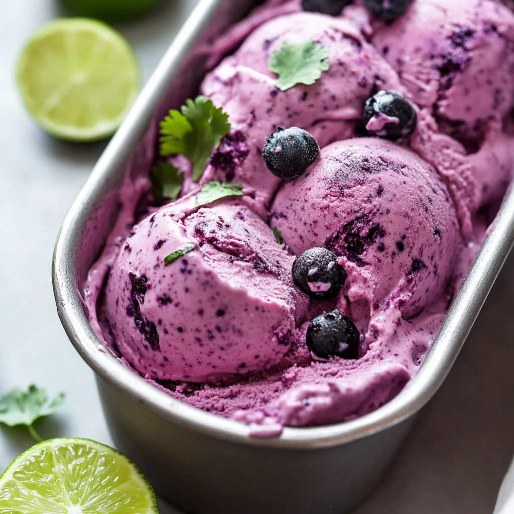 A container of blueberry ice cream with limes on the side.