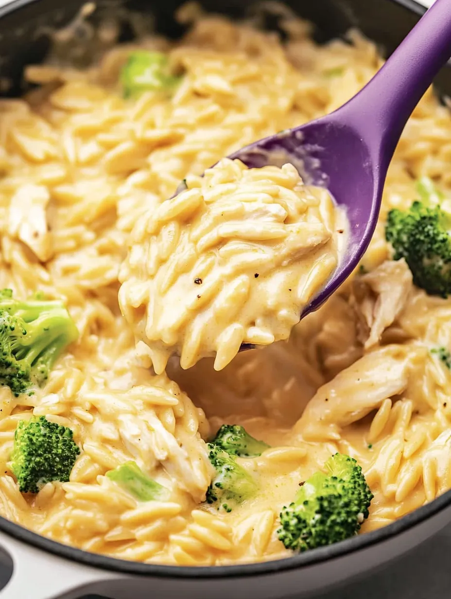 A spoon is scooping up food from a bowl.