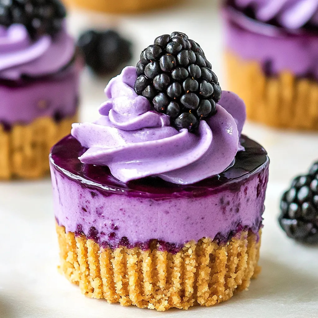 A cupcake with a blackberry on top.