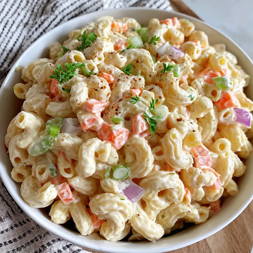 A white plate with a creamy macaroni-salad topping.