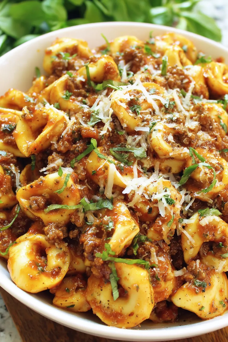 A bowl of pasta with meat sauce.