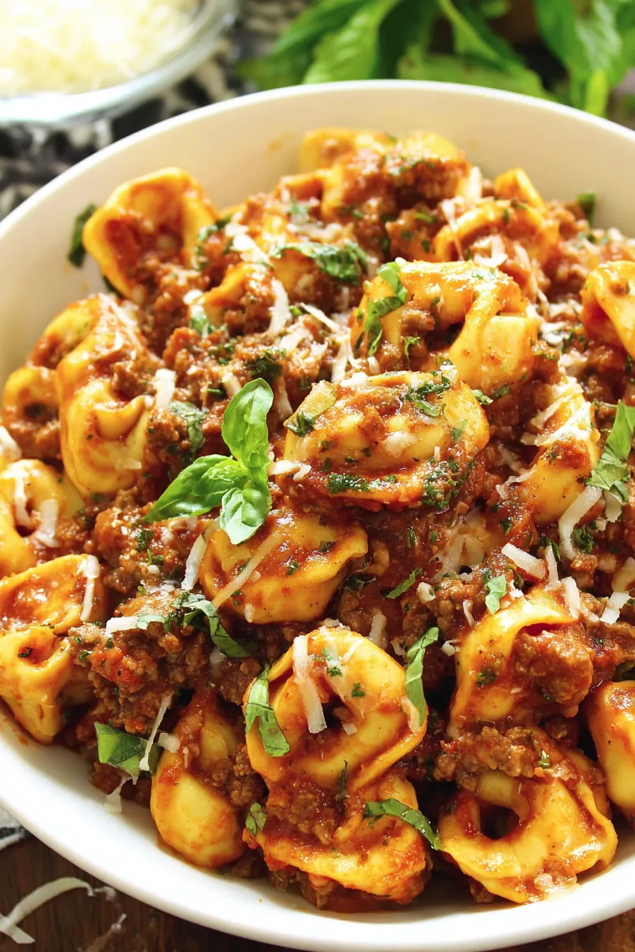 A bowl of pasta with meat sauce.
