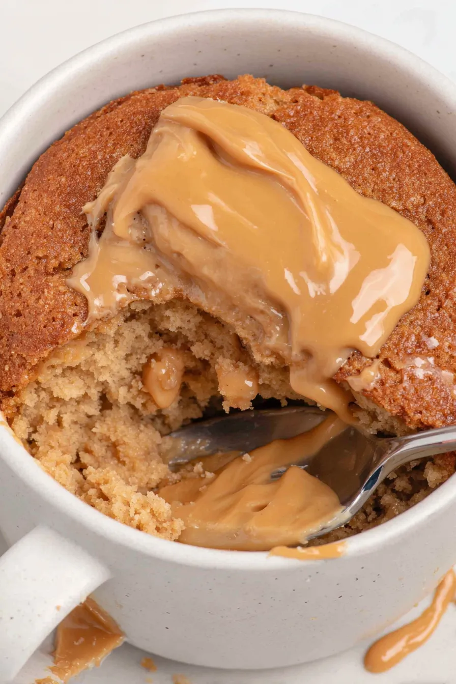 A spoonful of peanut butter on a muffin.