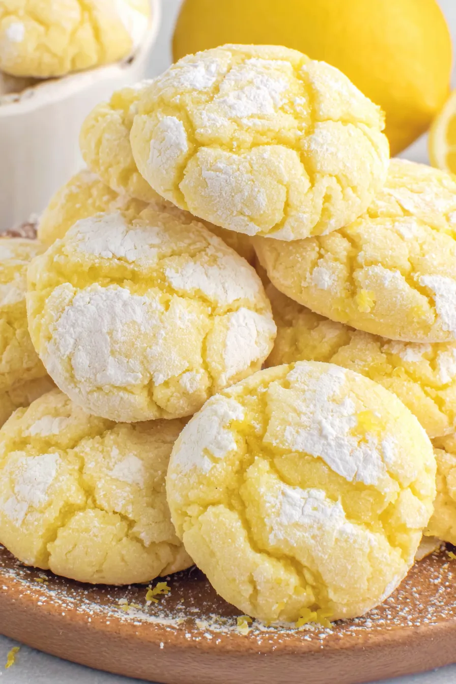 A stack of yellow cookies with white powder on top.