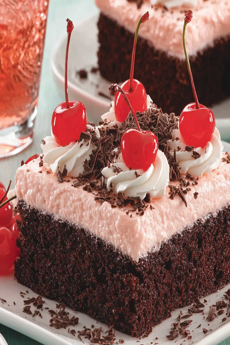 A slice of chocolate cake with cherries on top.